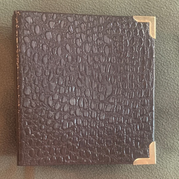 Other - New brown embossed photo album. 100 double-sided pages. Hold 5” x 7” photos.